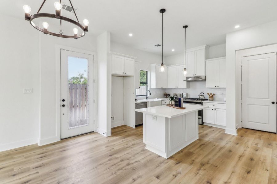 Open concept kitchen area. Including a breakfast bar.