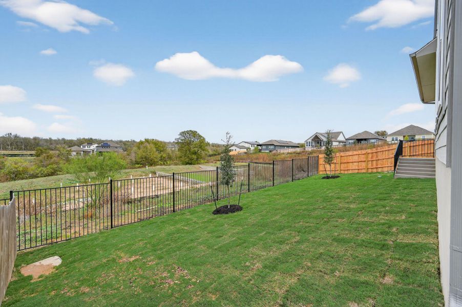 Fenced backyard featuring a residential view