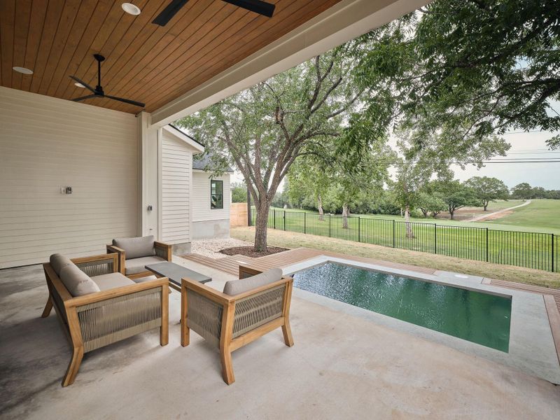 Fenced backyard featuring a ceiling fan, a patio, and an outdoor hangout area Fenced backyard featuring a ceiling fan, a patio, and an outdoor hangout area