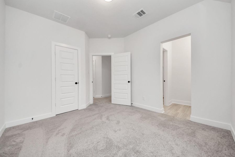 Upstairs Bedroom 3 with neutral tones, ample space, and a Jack-and-Jill bathroom connecting to the adjacent bedroom.