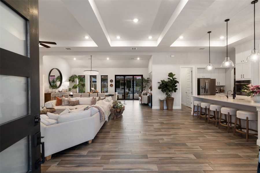 An open-concept living space with sleek flooring and elegant lighting creates an inviting atmosphere. An open-concept living space with sleek flooring and elegant lighting creates an inviting atmosphere.