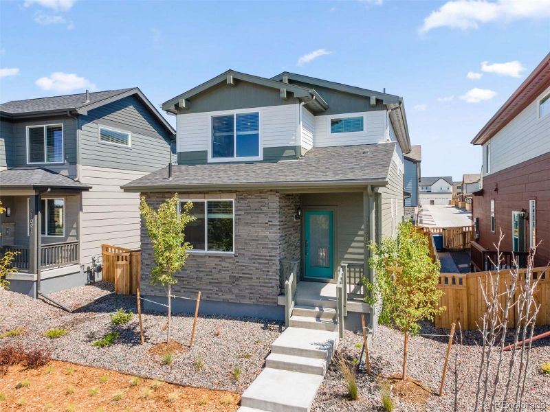 Front exterior of a new home in Woodrose at Painted Prairie, Aurora, CO, highlighting curb appeal (Image 26). Front exterior of a new home in Woodrose at Painted Prairie, Aurora, CO, highlighting curb appeal (Image 26).