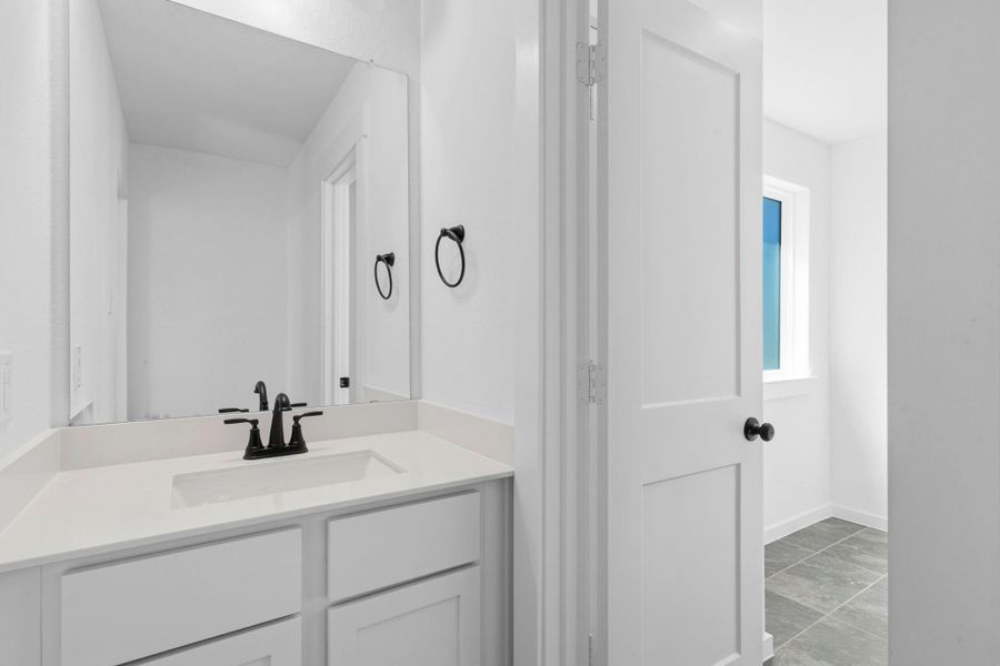 This secondary bath's fresh, timeless style ties in beautifully with the rest of the home’s design.