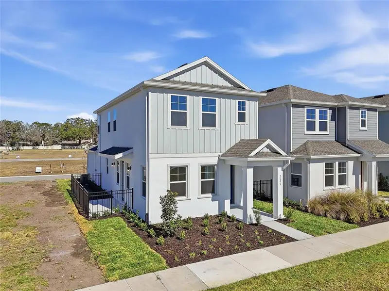 Front exterior of a new home in Vivir, Valrico, FL, highlighting curb appeal (Image 28).