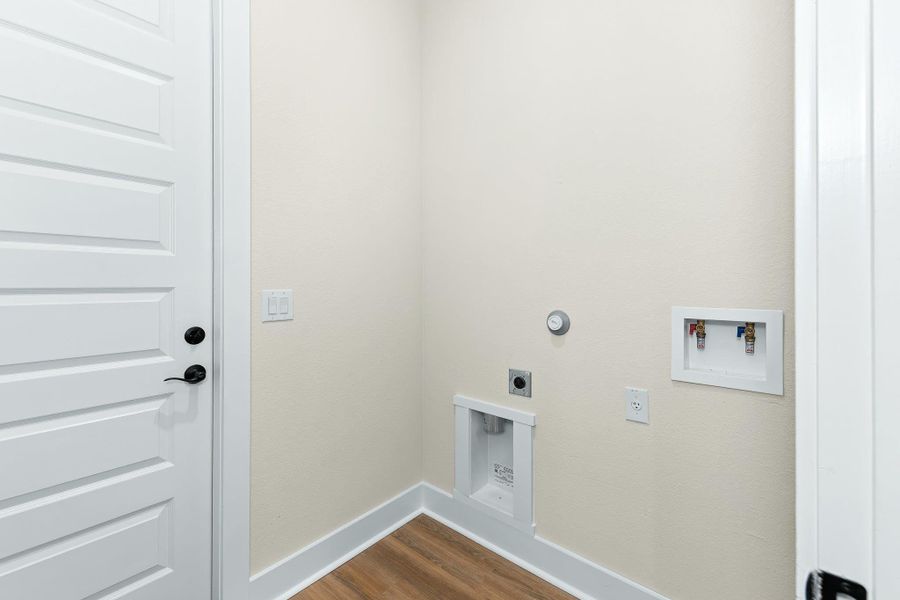 Washroom featuring dark wood-style floors, electric dryer hookup, hookup for a washing machine, and hookup for a gas dryer