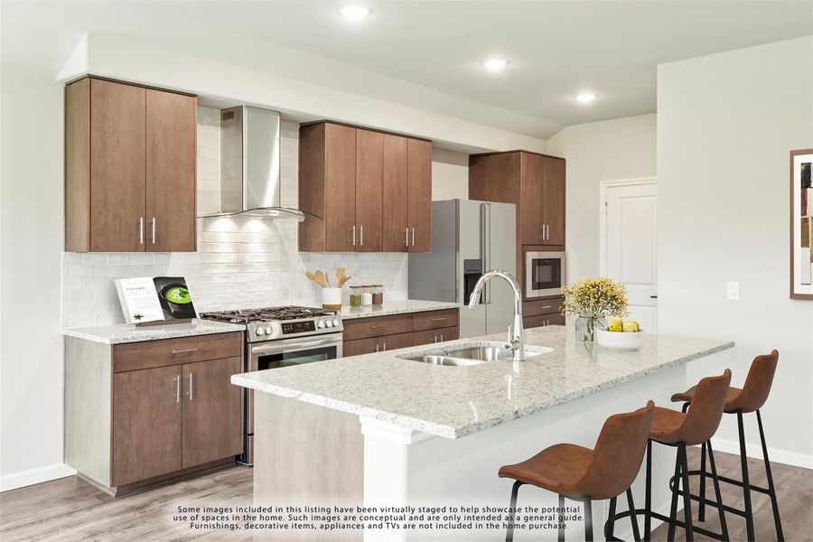 Kitchen with dark wood cabinets, granite island with sink, stainless steel appliances, and three bar stools