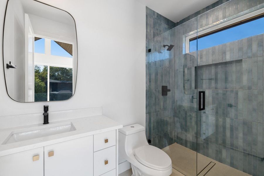 Full bath featuring vanity and a stall shower Full bath featuring vanity and a stall shower