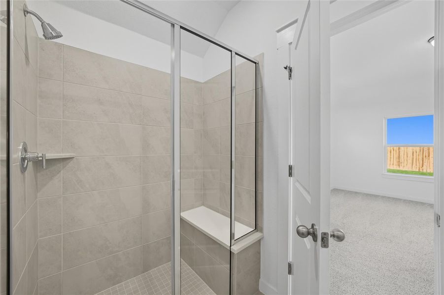 Bathroom featuring a shower stall and carpet floors