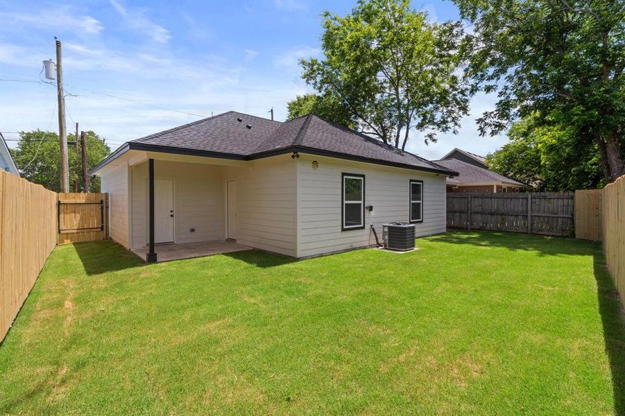 Rear view of house with roof with shingles, a fenced backyard, and a patio Rear view of house with roof with shingles, a fenced backyard, and a patio
