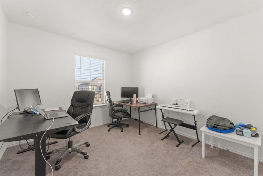 Office space featuring baseboards and light colored carpet