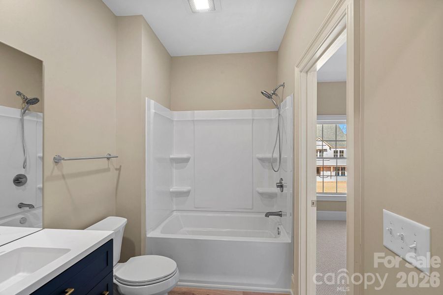 Guests will appreciate this private retreat, complete with an ensuite bath and a generous walk-in closet with custom shelving.