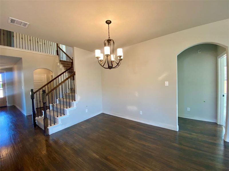 Dining area with rich hardwoods and chandelier