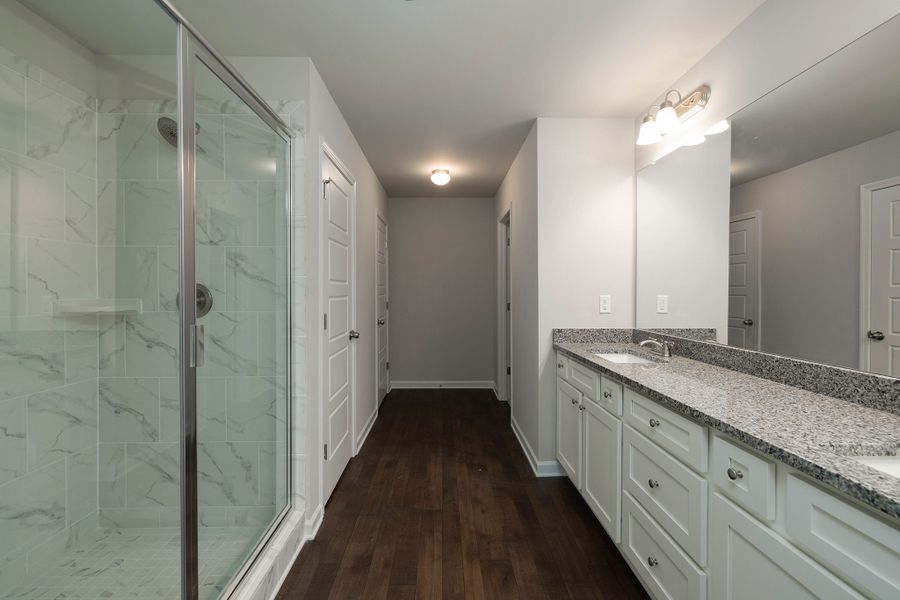 Luxurious primary bathroom with dual vanities