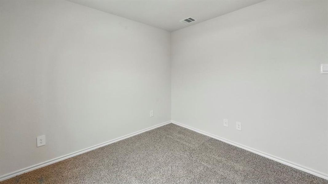 Carpeted spare room with baseboards
