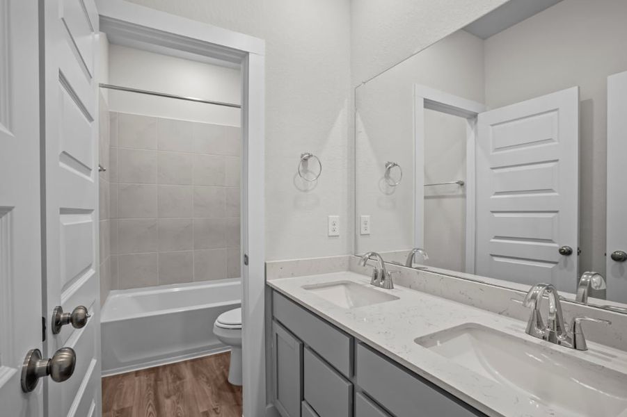 A bathroom with a sink and a bathtub. A bathroom with a sink and a bathtub.