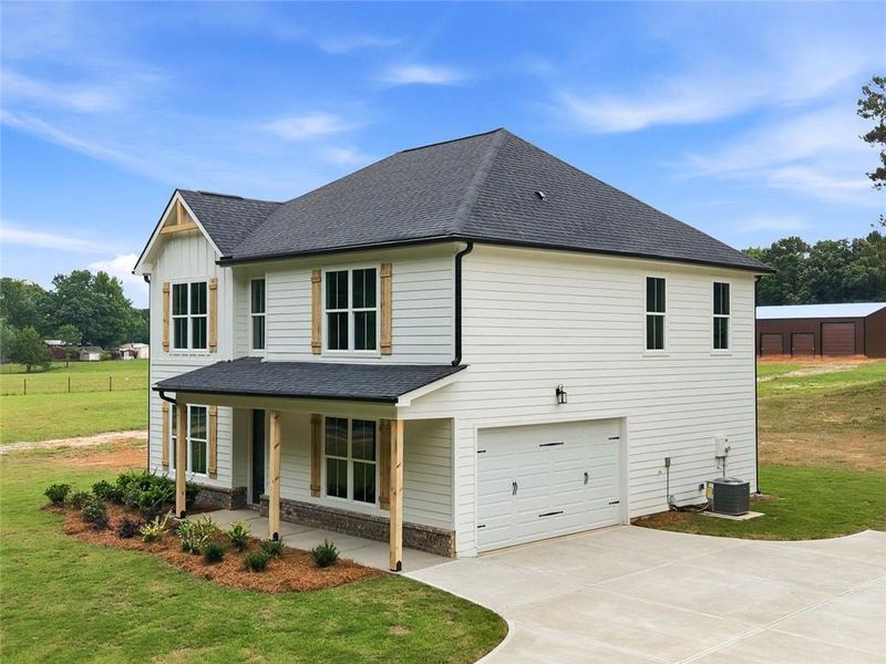 Front exterior of a new home in , Mansfield, GA, highlighting curb appeal (Image 32). Front exterior of a new home in , Mansfield, GA, highlighting curb appeal (Image 32).