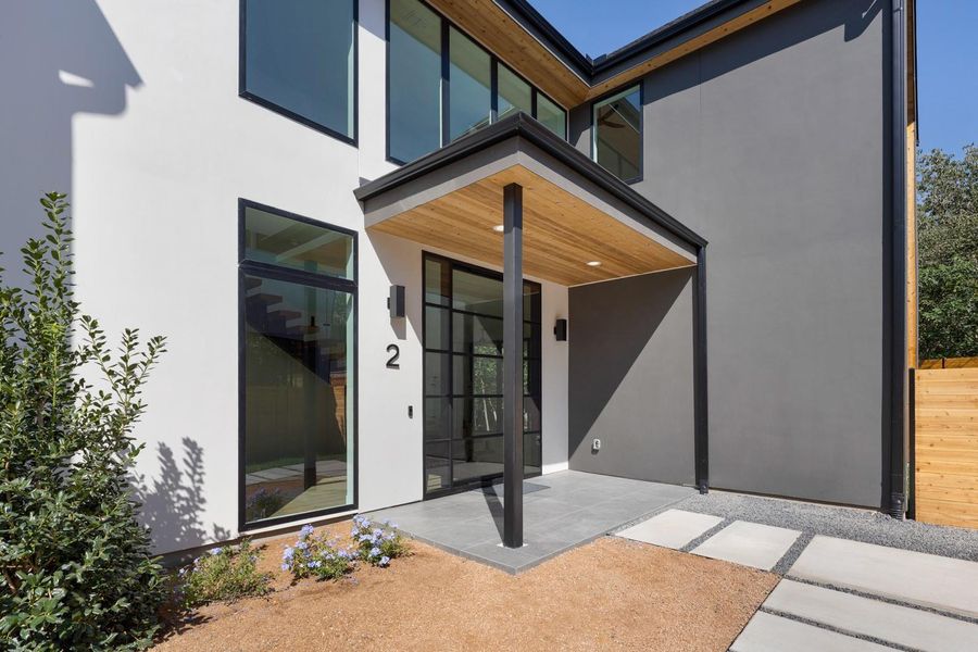 Entrance to property with stucco siding
