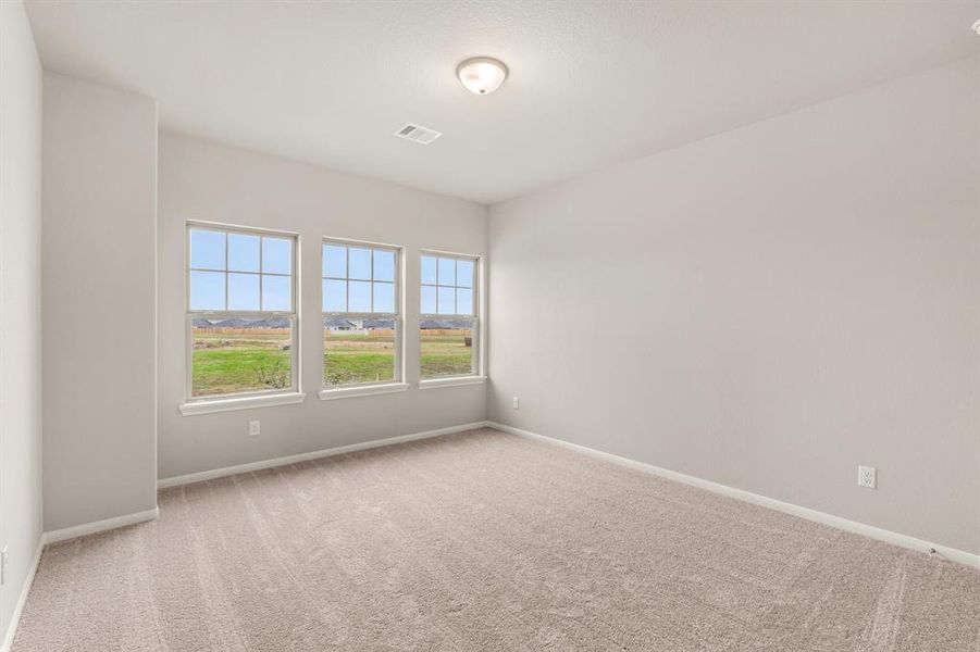 Your secondary bedroom features plush carpet, fresh paint, closet, and a large window that lets in plenty of natural lighting.