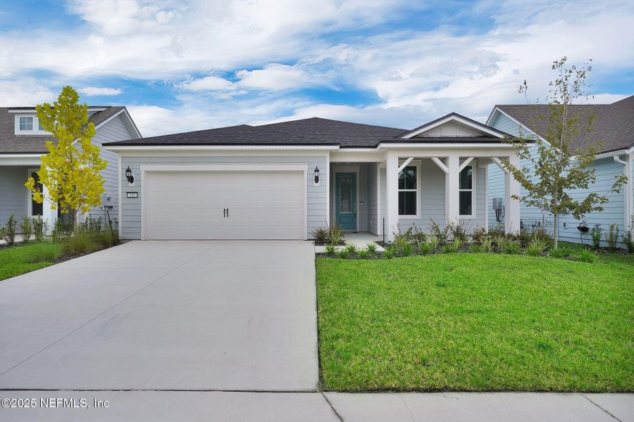 Front exterior of a new home in Summer Bay at Grand Oaks, St. Augustine, FL, highlighting curb appeal (Image 23).
