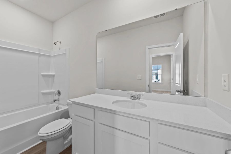 Furnished interior view inside a new home in Blue Heron Retreat: Villas, Little River (Image 6).