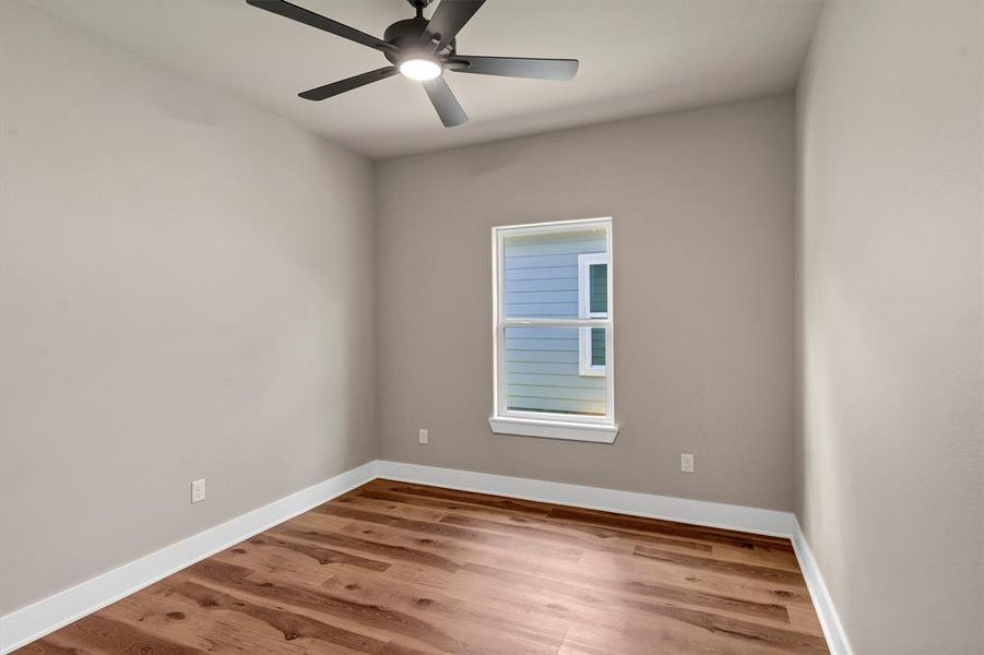 Unfurnished room featuring light wood-style floors and ceiling fan Unfurnished room featuring light wood-style floors and ceiling fan