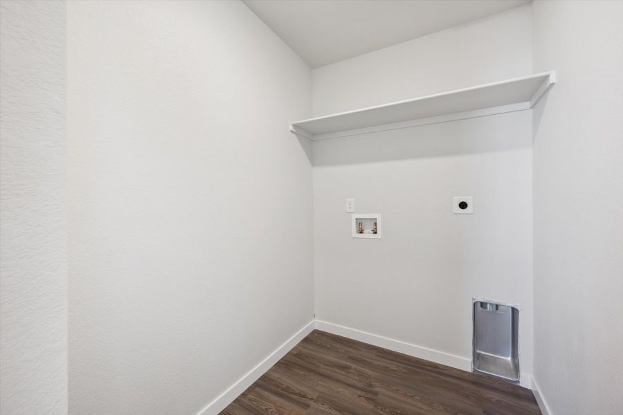 A white room with a wood floor.