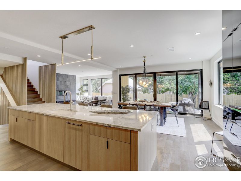 Chef's kitchen with Thermador appliances custom white oak and high gloss flat panel cabinetry **Temporary stove, will be replaced with the Thermador 48" Gas Pro Grand Range with Griddle