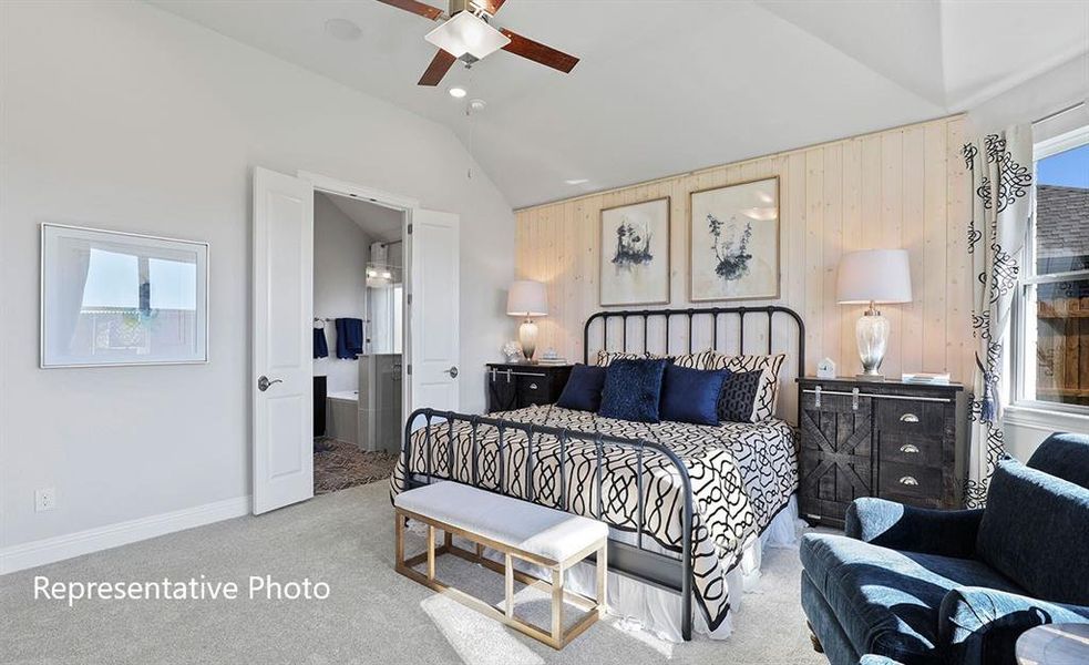 Carpeted bedroom featuring a vaulted ceiling with a ceiling fan, a shiplap accent wall, and a window with patterned drapes