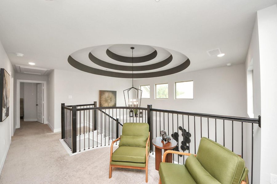 Flexible upstairs space with overlook and striking concentric ceiling.
