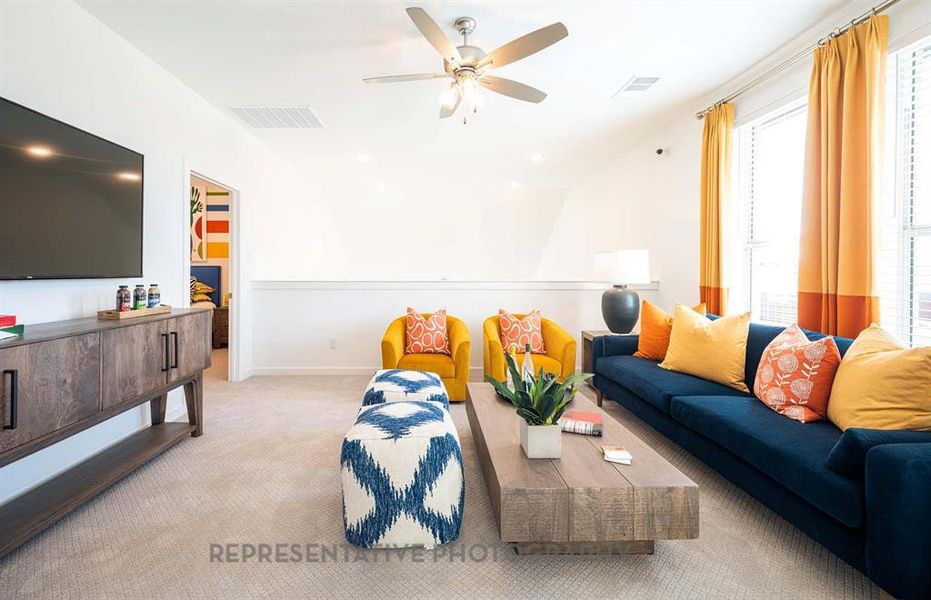 Living room featuring carpet and ceiling fan