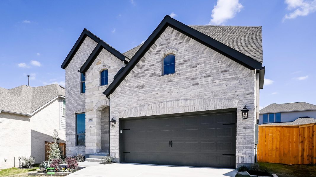 Front exterior of a new home in 6 Creeks, Kyle, TX, highlighting curb appeal (Image 16).