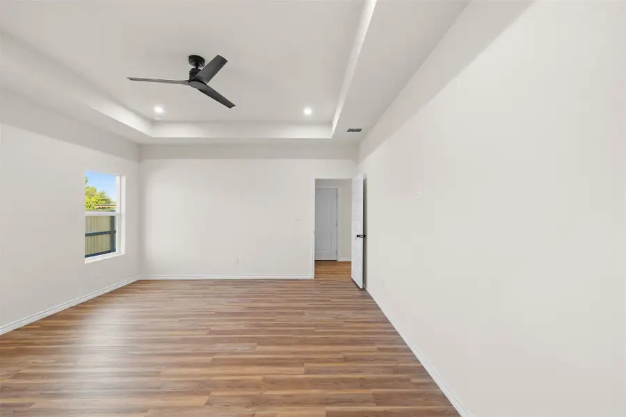 Unfurnished room featuring a tray ceiling, light wood-style flooring, recessed lighting, and ceiling fan Unfurnished room featuring a tray ceiling, light wood-style flooring, recessed lighting, and ceiling fan