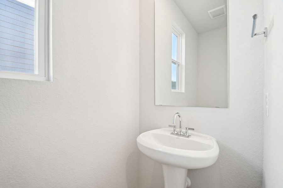 A bathroom with a sink and mirror.