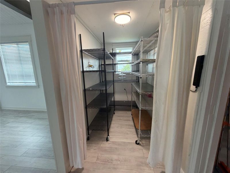 Pantry. Well-lit utility space with abundant shelving for organized storage needs.