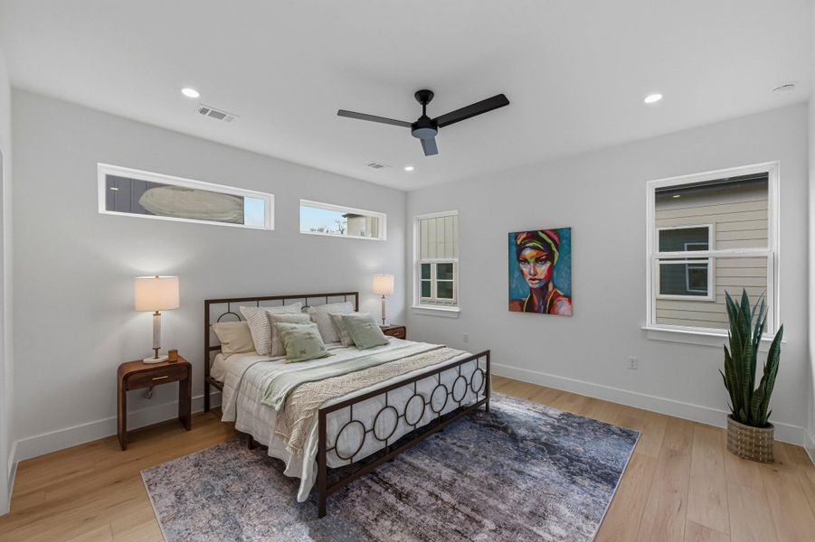 Bedroom featuring light wood-style floors, a ceiling fan, and recessed lighting