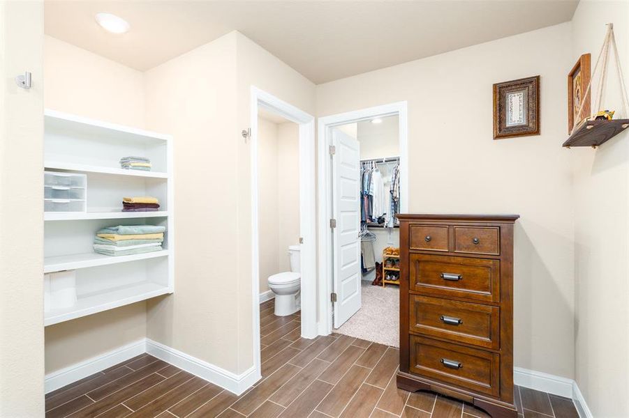 Large ensuite showing shelves, toilet area, closet and enough space for a jewelry cabinet or floor length mirror.