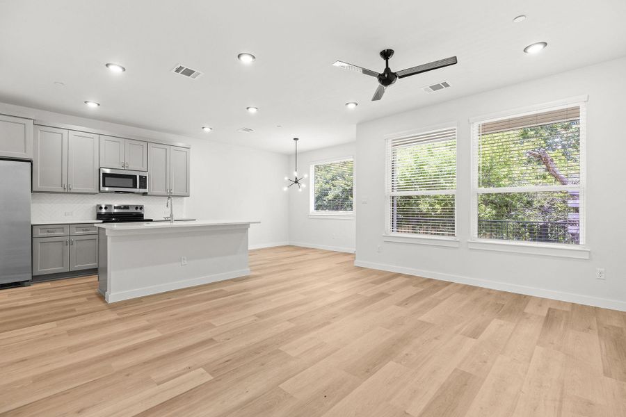 A contemporary open-concept space features light hardwood floors and abundant natural light. A contemporary open-concept space features light hardwood floors and abundant natural light.