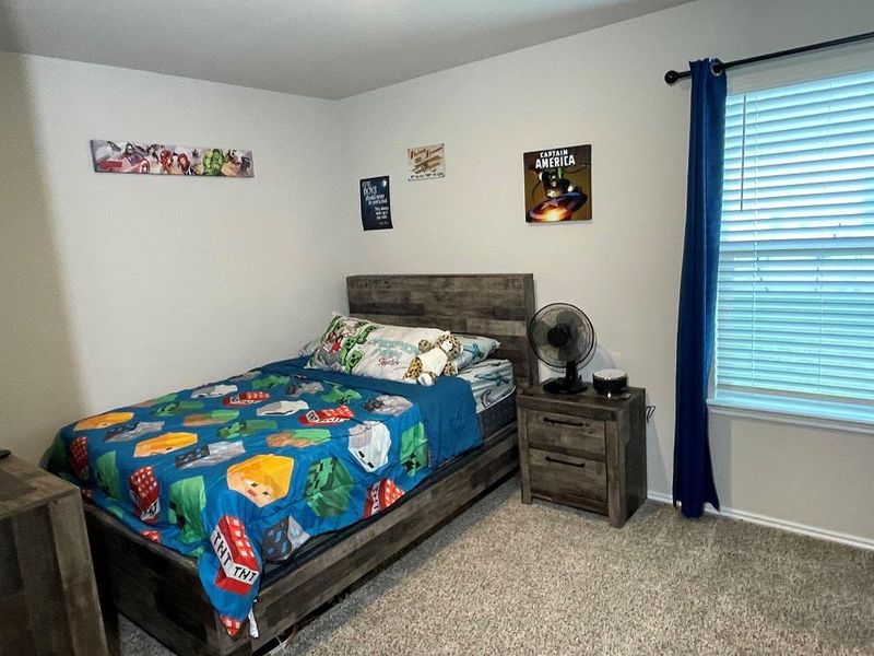 Bedroom featuring carpet flooring and baseboards