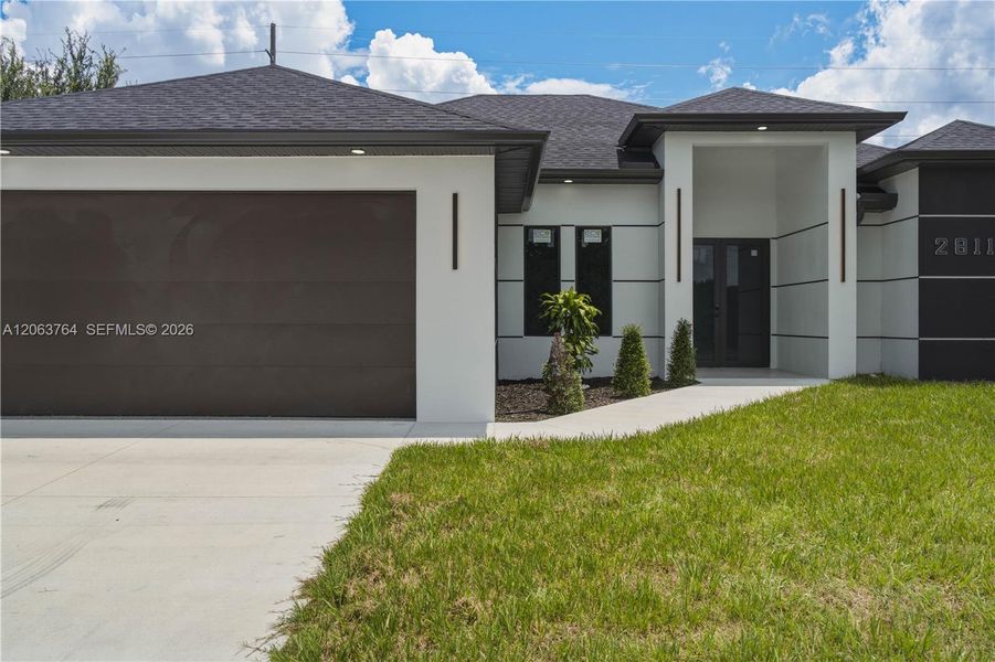 Front exterior of a new home in , Lehigh Acres, FL, highlighting curb appeal (Image 17).