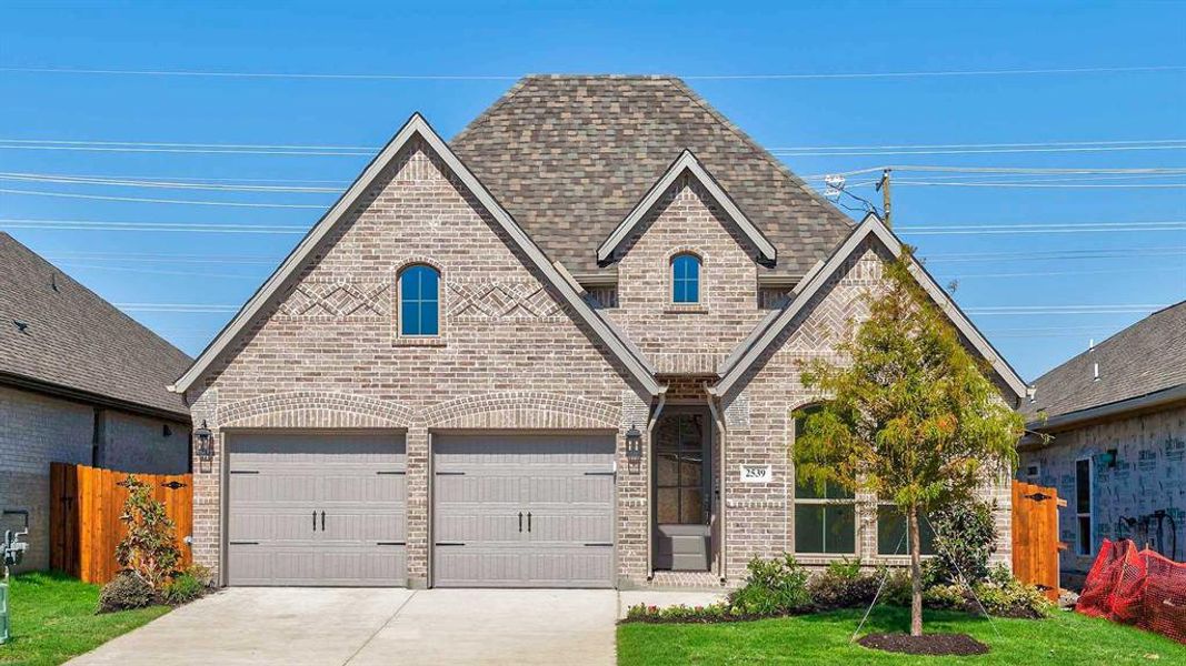 Front exterior of a new home in Avondale 45', Fate, TX, highlighting curb appeal (Image 1). Front exterior of a new home in Avondale 45', Fate, TX, highlighting curb appeal (Image 1).
