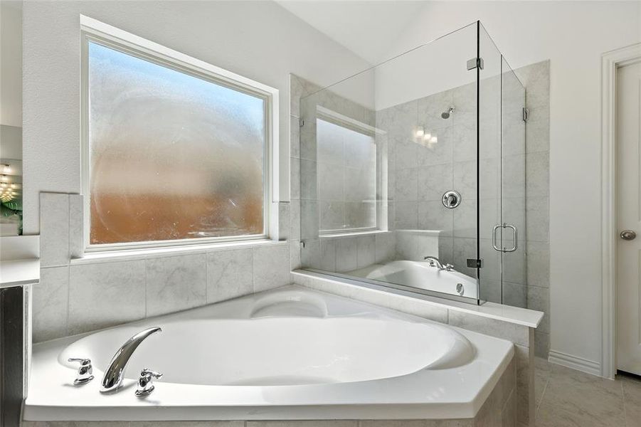 Full bath with a stall shower and a garden tub