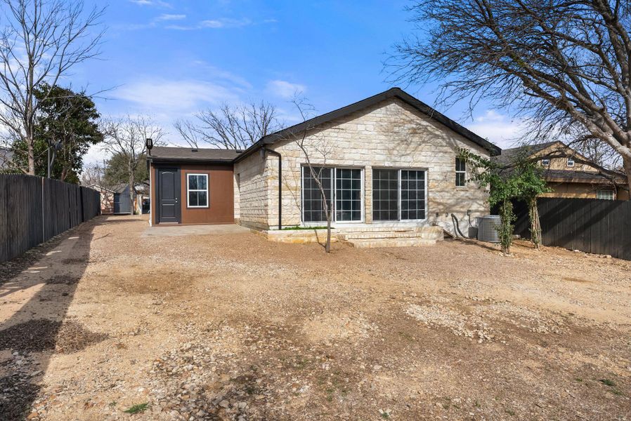 Back of property featuring a patio area and stone siding