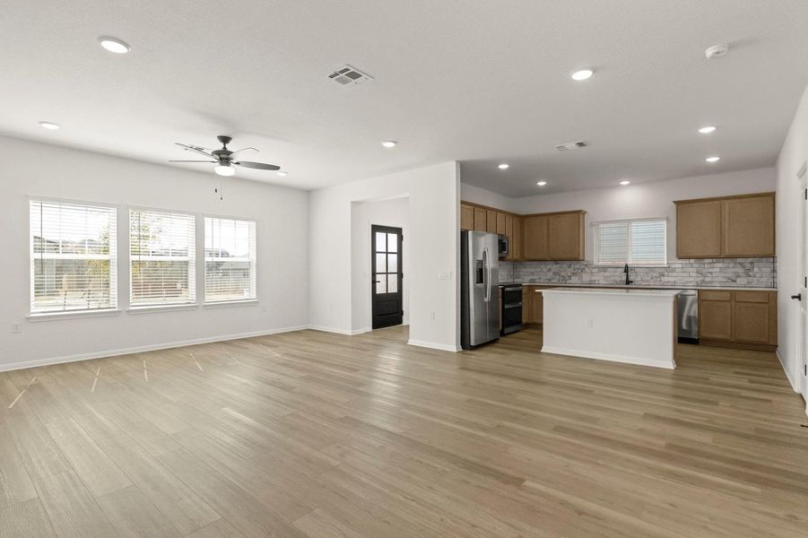Kitchen featuring open floor plan, a kitchen island, plenty of natural light, stainless steel appliances, and recessed lighting