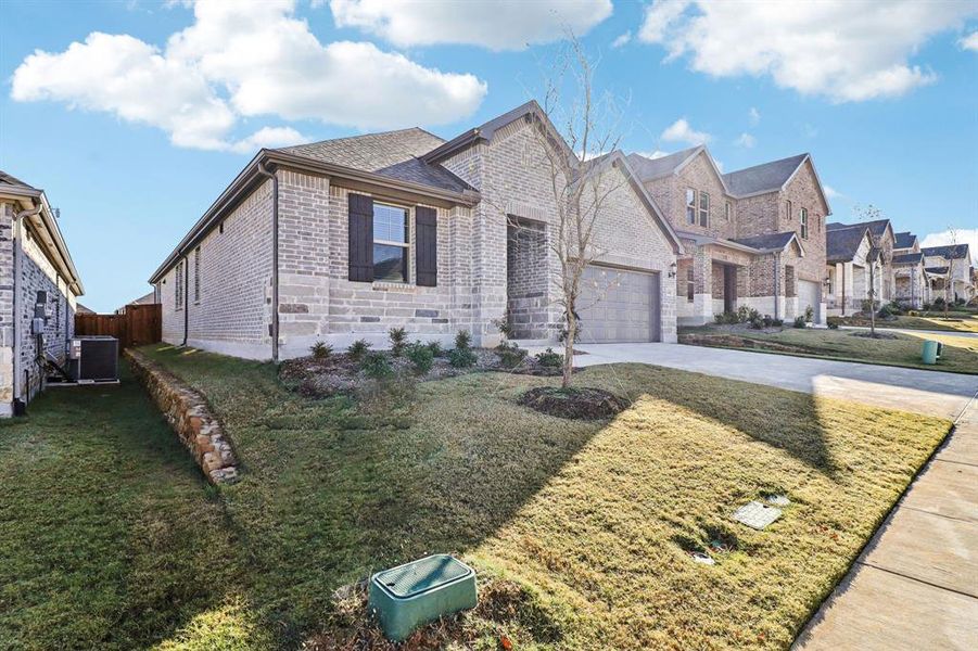 Front exterior of a new home in Ashford Park - Texana Series, Corinth, TX, highlighting curb appeal (Image 20). Front exterior of a new home in Ashford Park - Texana Series, Corinth, TX, highlighting curb appeal (Image 20).