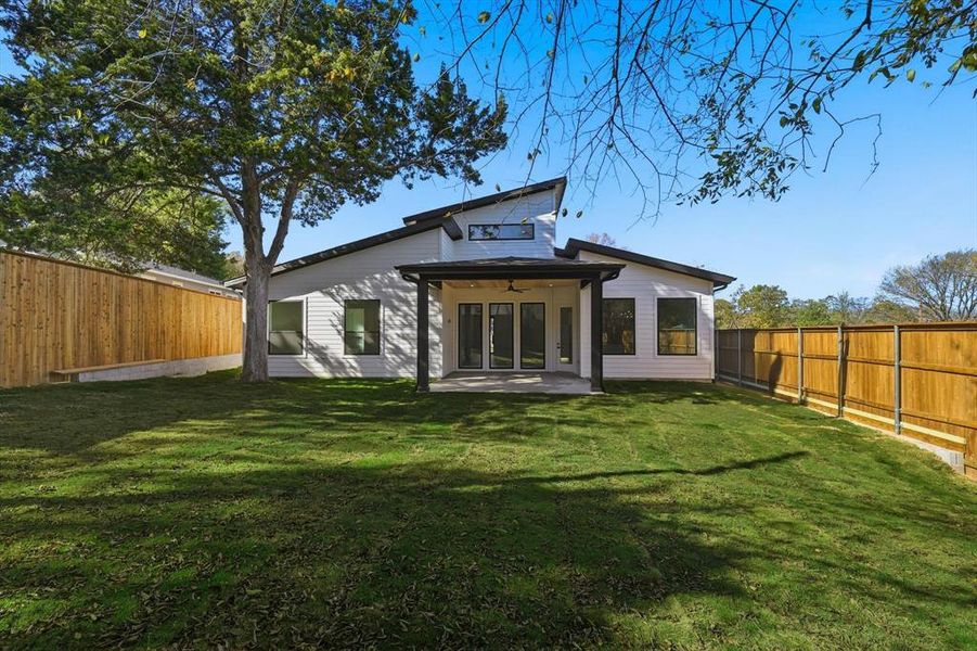 Back of property with ceiling fan, a patio area, and a fenced backyard Back of property with ceiling fan, a patio area, and a fenced backyard