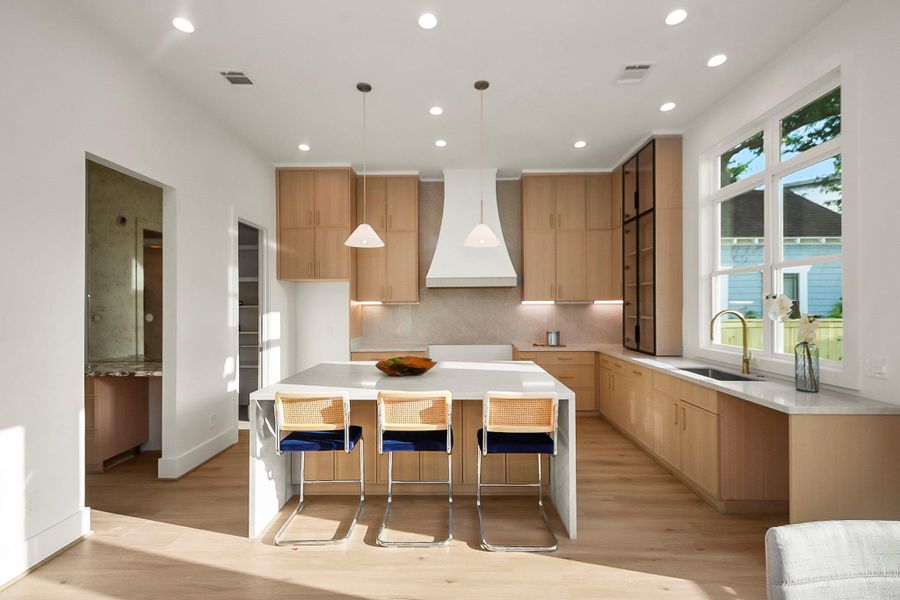 The kitchen is the heart of the home, showcasing designer selections, generous prep space, and an open-concept layout that flows seamlessly into the living area.