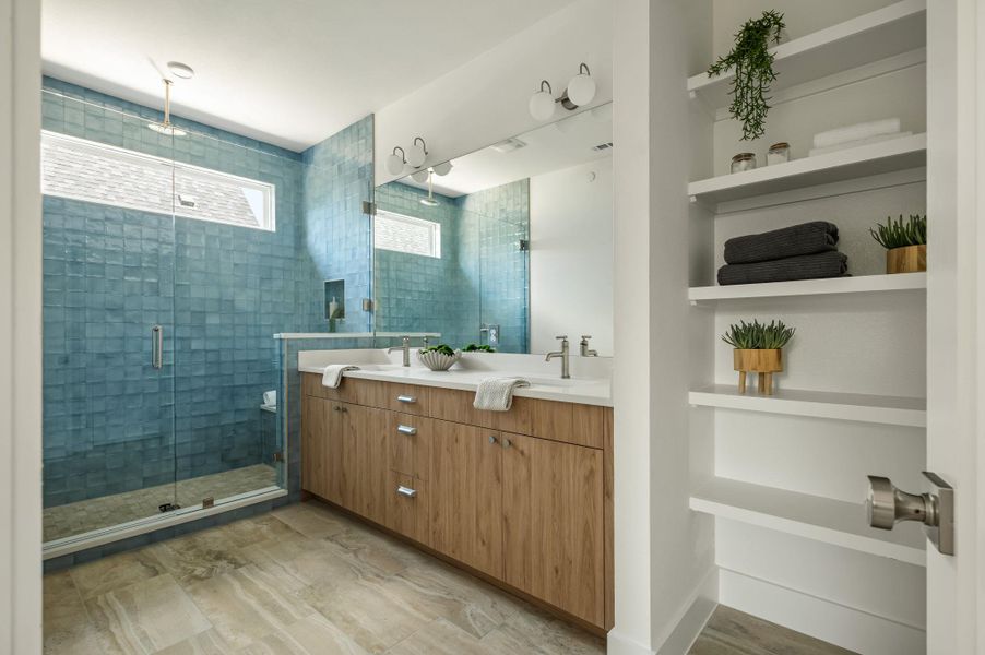 A spa-like primary bathroom with dual vanities and a spacious walk-in shower. A spa-like primary bathroom with dual vanities and a spacious walk-in shower.