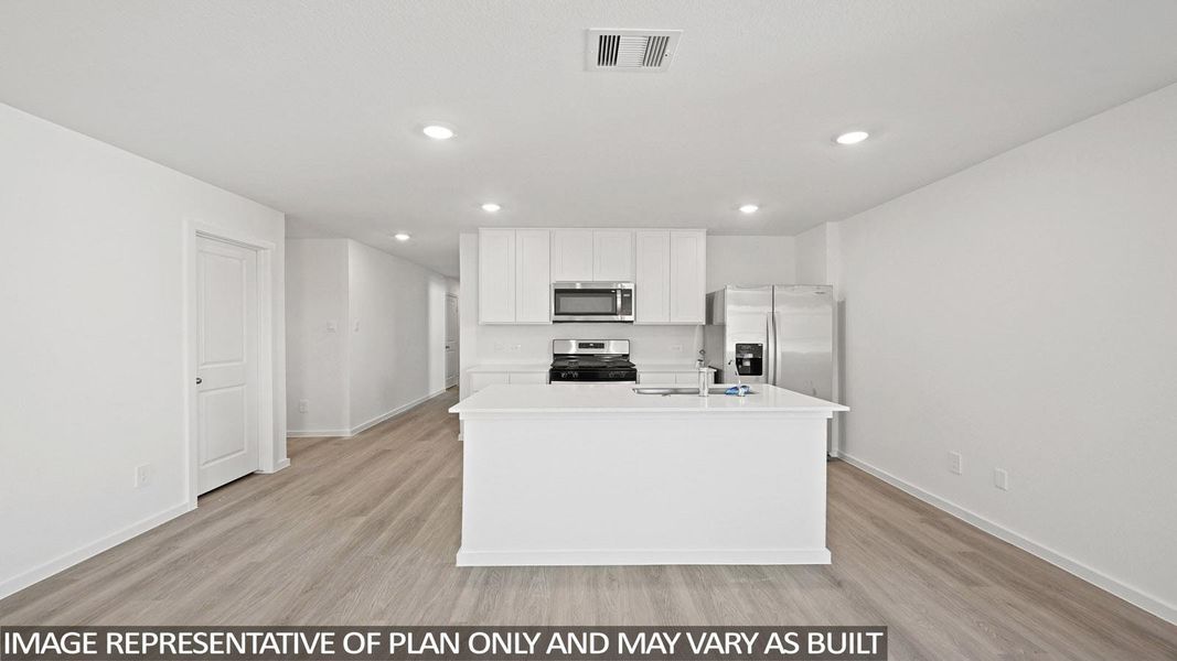Kitchen featuring a center island with sink, light wood-style flooring, white cabinets, stainless steel appliances, and recessed lighting