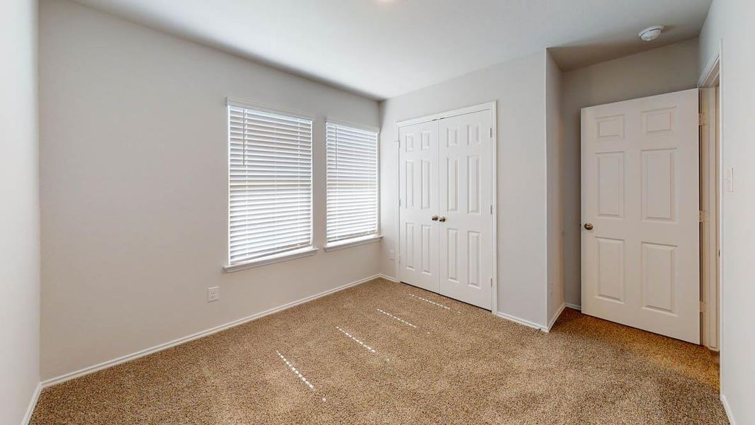 Unfurnished bedroom with carpet and a closet