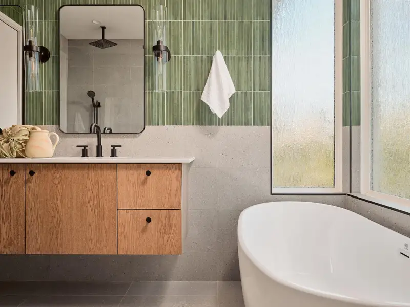 Full bath with a soaking tub, vanity, tile walls, and tiled shower